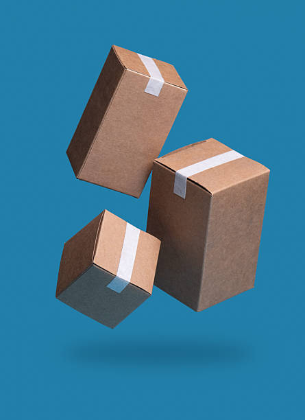 istock Closed and taped cardboard parcel boxes falling on blue background, Ideal for Shipping, Delivery 2223231976