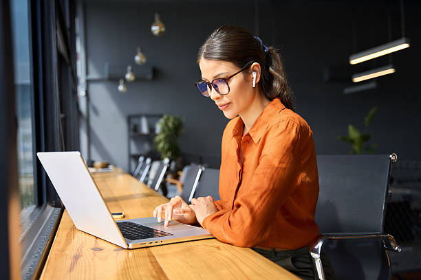 istock Indian entrepreneur manager businesswoman using pc for communication, learning at workplace. Focused latin hispanic young business woman working on laptop computer sitting at office workplace desk 2223235819