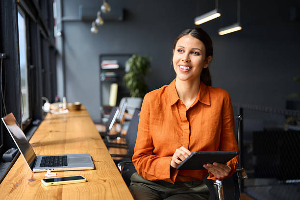 istock Executive CEO businesswoman professional holding digital tablet pc device for work in office, looking dreaming at copy space. Successful latin hispanic young woman using pad computer for business app 2223235841