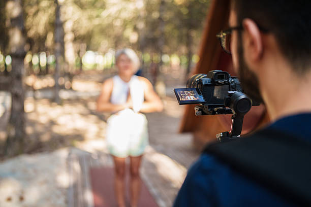 istock Behind the Scenes: Cameraman and Model in Nature 2223236652