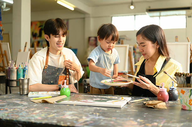 istock A mother and her young son participate in a special art class with support from a friendly instructor. 2223237366