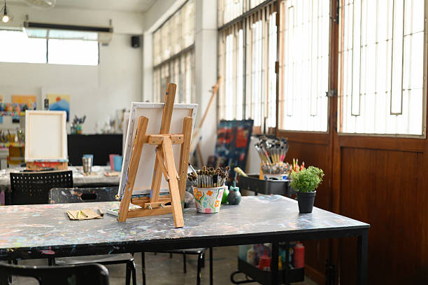 istock Empty Art Classroom with Easels and Paint Supplies 2223237450
