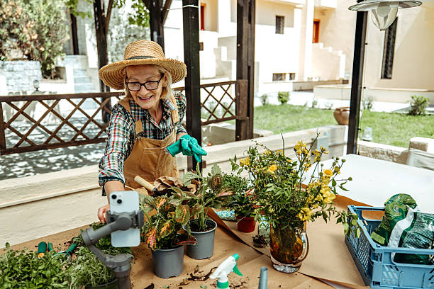 istock Casually dressed mature woman vlogging about gardening in backyard 2223237547