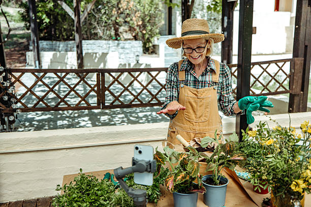 istock Casually dressed mature woman vlogging about gardening in backyard 2223237565