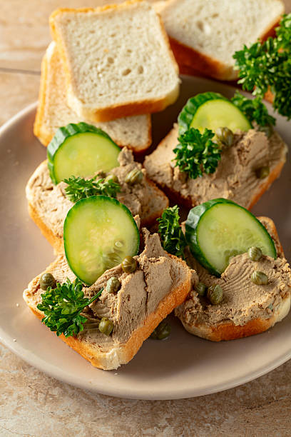 istock Open sandwiches with pate, cucumber, capers, and parsley. 2223237584