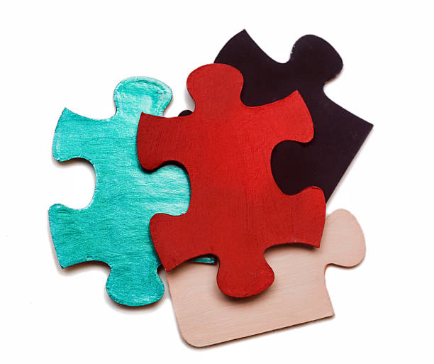 Assortment of single-color jigsaw puzzle pieces, isolated on white.