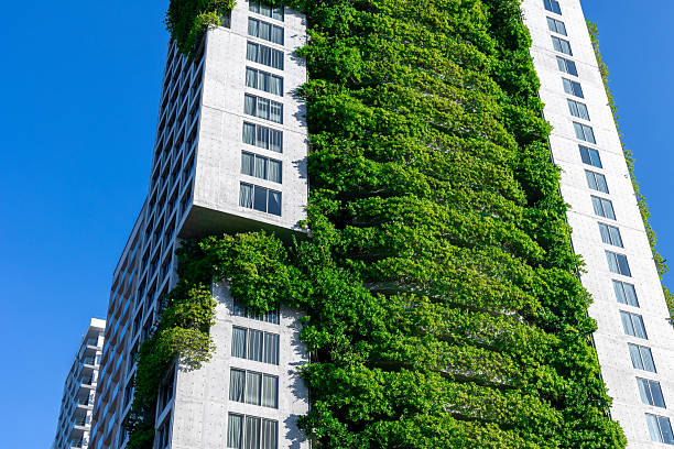 Modern urban architecture with vertical garden on high-rise building.