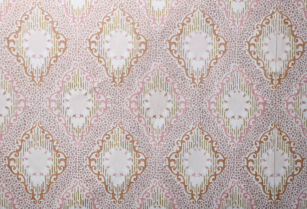 Old wallpaper on the wall. Old wallpaper for texture or background.