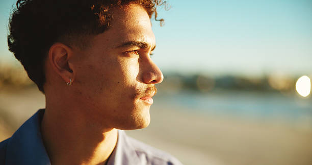istock Sunset, thinking and ocean with man, vacation and nature with memory, reflection and decision Seaside, summer holiday and person with weekend break, wonder and choice with peace, beach or travelling 2223240310