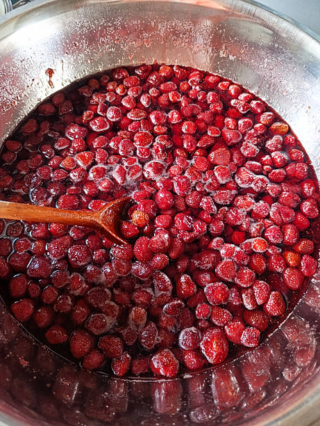 istock Pot filled with strawberry jam and wooden spoon 2223240687