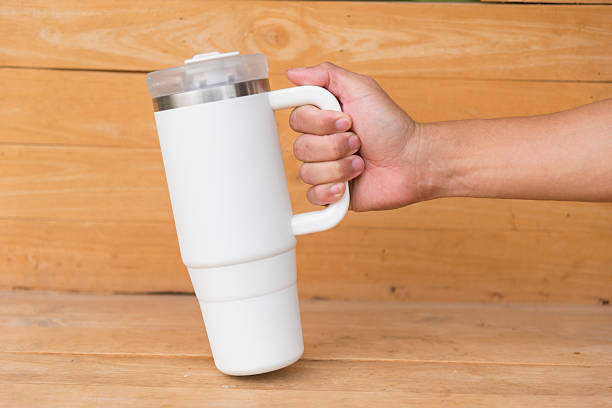 istock White HANDLE TUMBLER on wood table 2223241783