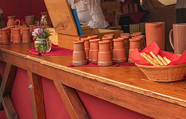 istock Medieval-style market stand with clay mugs, breadsticks, and rustic decor in Bavaria 2223241950