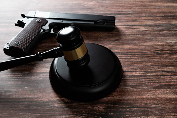 istock Gun and gavel on the table 2223242116
