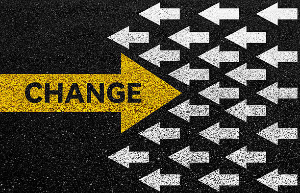 istock Big yellow arrow opposite direction with white arrows on asphalt road 2223242568