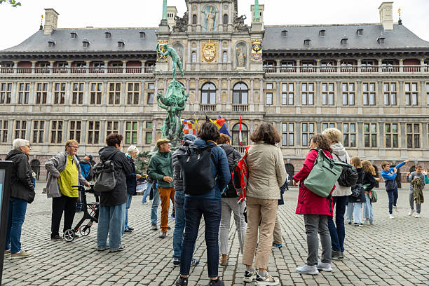 Antwerp, Belgium—June 5, 2025: an elderly tourism group in front of city hall