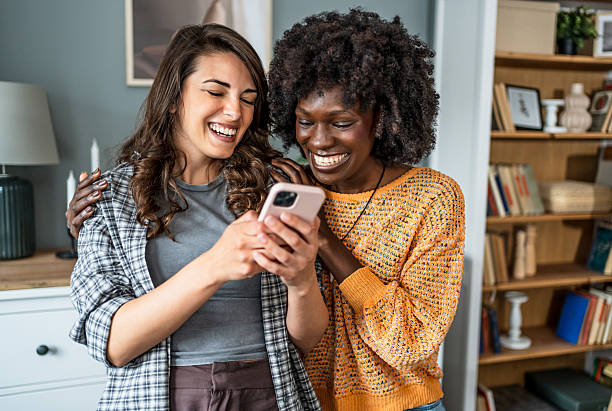 istock Young women laughing together at home 2223246244