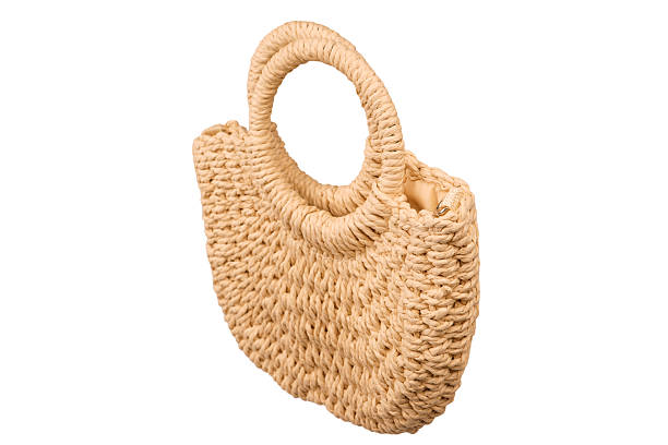 istock A beige straw bag isolated on a white background. 2223248309