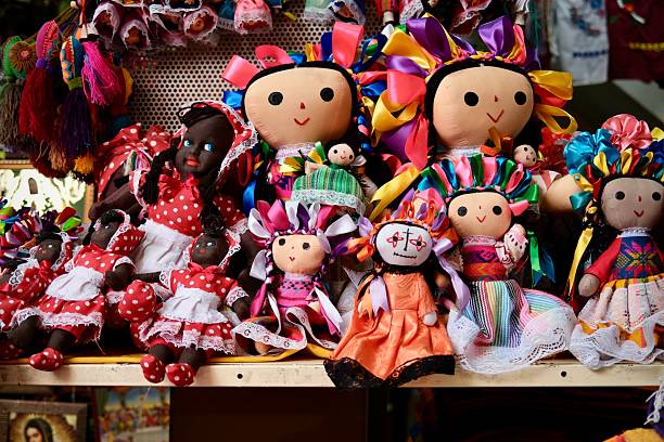 Mexico City, CDMX, Mexico- February 19, 2025: A lively market stall filled with traditional Mexican rag dolls, featuring colorful ribbons, embroidered dresses, and intricate handcrafted details.