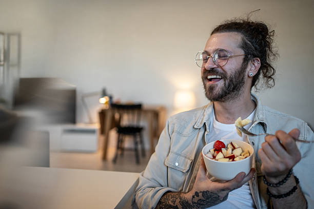 istock Happy freelancer enjoying a healthy fruit salad at home 2223249581