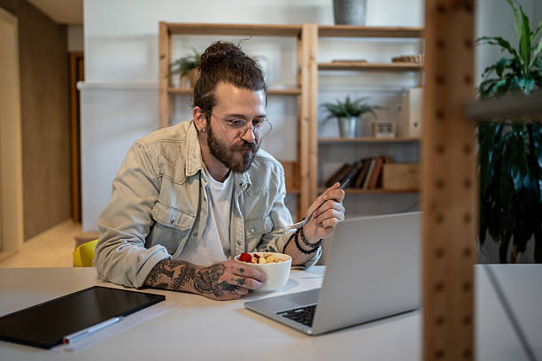 istock Young freelancer working from home and eating breakfast 2223250133