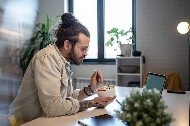 istock Freelancer enjoying a healthy breakfast while working from home office 2223250200