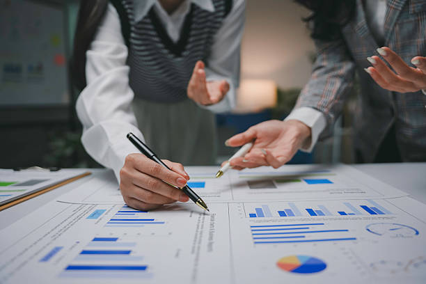 istock Professional women reviewing financial charts, analyzing business data while collaborating in modern corporate workspace 2223252283