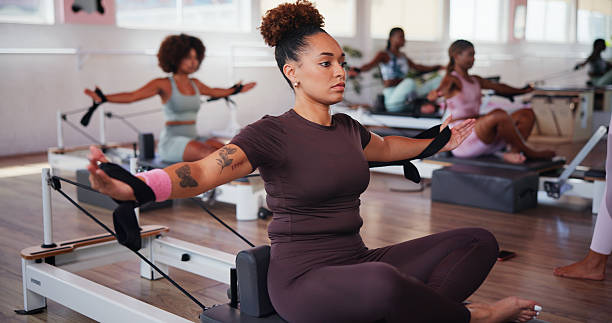 istock Exercise, pilates and reformer with woman in class for improvement, training or workout routine. Concentration, equipment and fitness with person on machine in studio for challenge or performance 2223252875