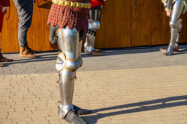 istock medieval knights in plate armor standing on cobblestone ground, historical reenactment scene 2223254277