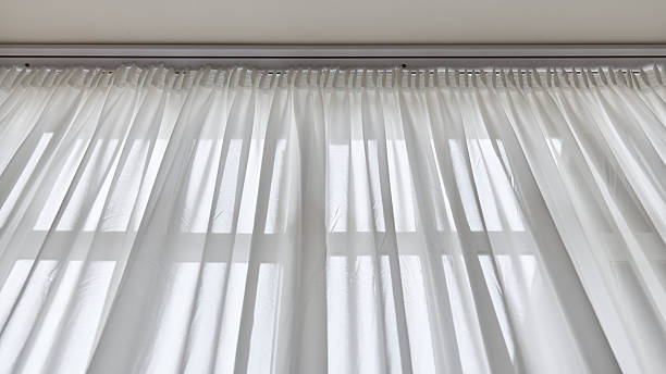 istock Light through sheer white curtains in a bright room 2223256279