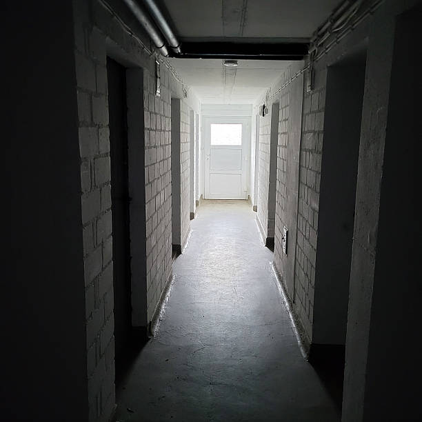 istock A concrete basement corridor disappearing into the darkness. 2223256940
