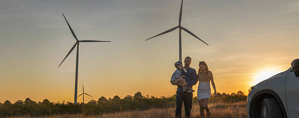 istock Family with son walking on field on wind farm 2223258945