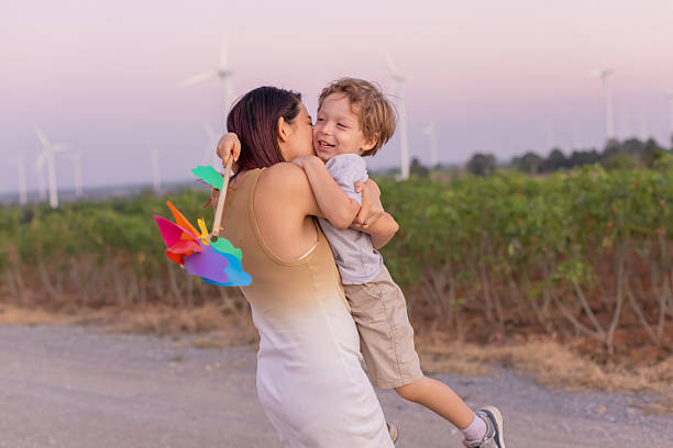 istock Family with son walking on field on wind farm 2223258949
