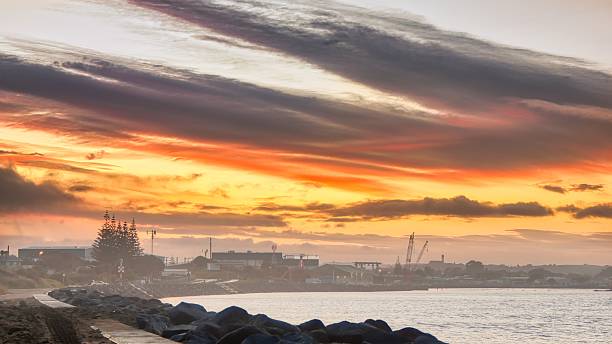 Whanganui city industrail wharf area, with a wonderful sunrise sky and a light morning mist.