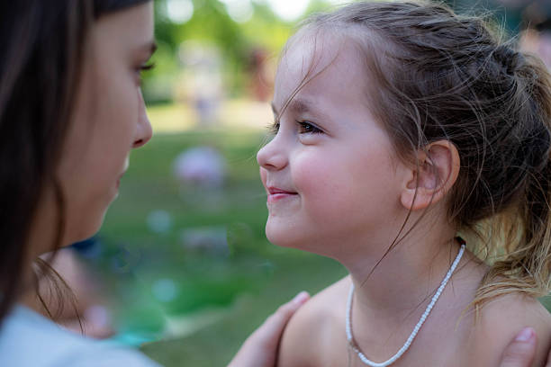 A family portrait of two Hawaiian girls, preteen sisters. Photographed Outdoor in Kauai, Hawaii.