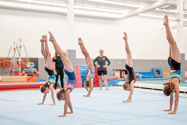 istock Young Gymnasts Practicing Handstands in a Well-Lit Training Facility 2223261872