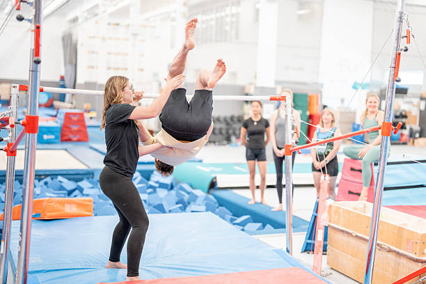 istock Gymnastics Training Session with Students Practicing Under Coach's Guidance in Gymnasium 2223263662