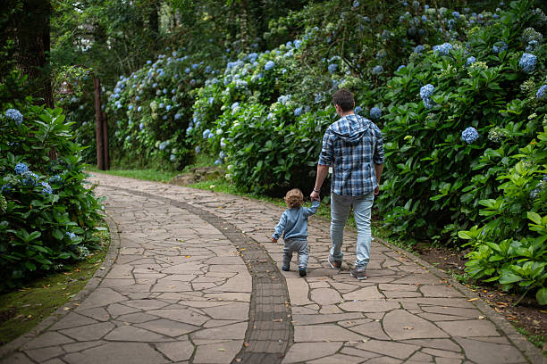 Father and 16-month-old baby son taking a walk