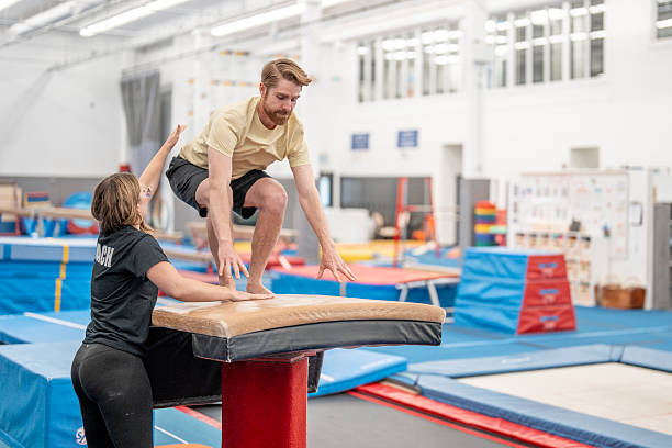 istock Gymnast Practicing Vault Skills Under Coach Supervision in a Training Facility 2223265707