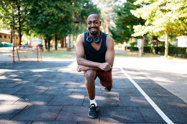 istock Young sportsman stretching legs before running in a park 2223266513