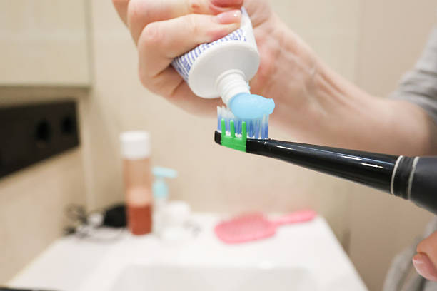 istock Woman Following Morning Bathroom Routine in Bathrobe 2223268504