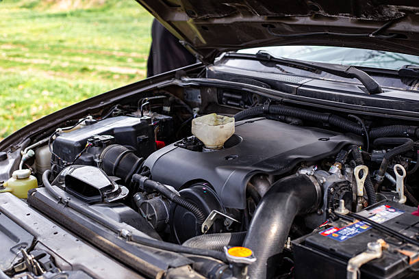 istock Car engine with open hood, engine components and funnel for filling engine oil 2223268903