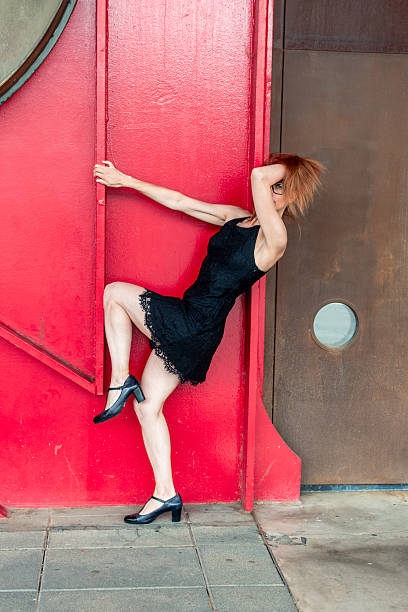 istock Redhead dancer performing against a red metal wall 2223272215