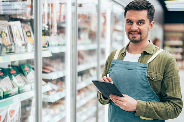 istock Supermarket Employee Taking Inventory with Digital Tablet 2223272862