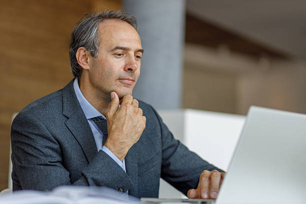 istock Pensive businessman working on laptop in office 2223273740