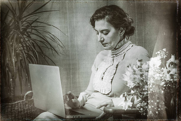 istock Elegant woman using laptop in vintage setting with flowers 2223275239