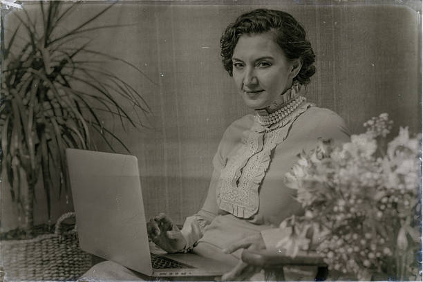 istock Elegant woman using laptop in vintage setting with flowers 2223275291