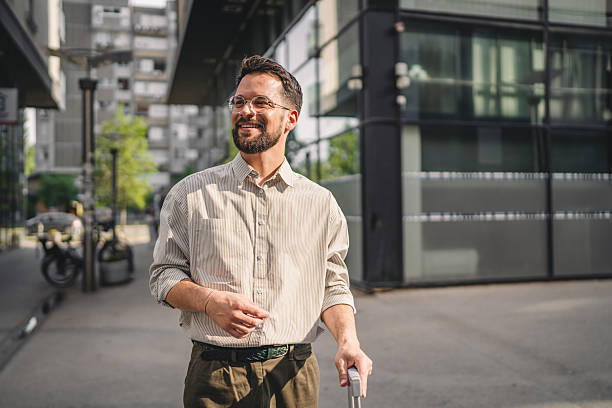 istock man passenger tourist with suitcase walking past modern architecture 2223275540