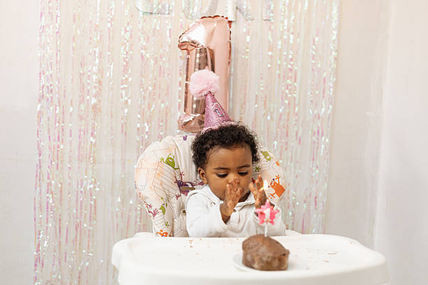 Black baby celebrating her first 1st birthday at home.