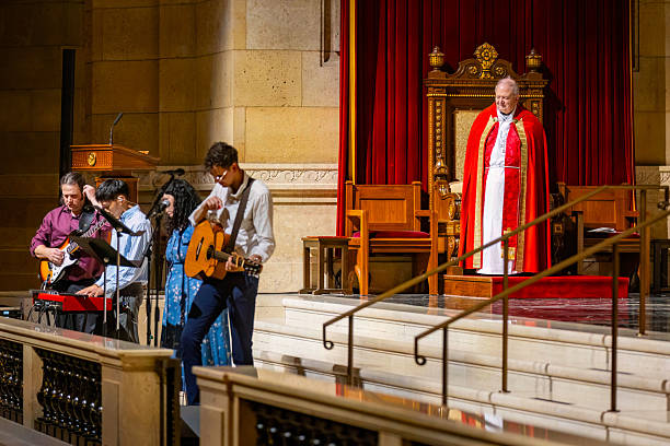 St Paul, MN, USA - June 07, 2025: People engaged in prayer and singing within the magnificent interior of the Cathedral of Saint Paul