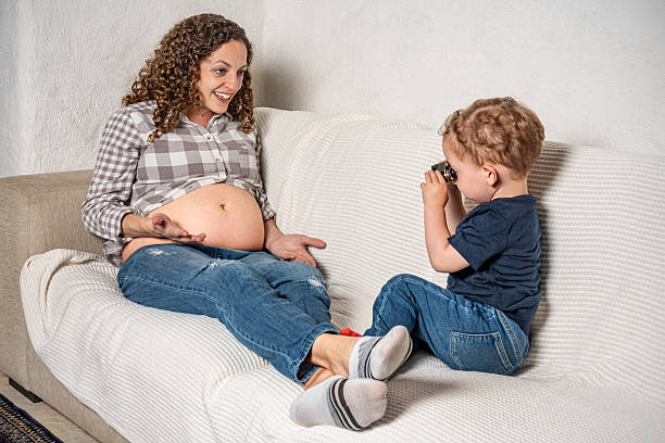 An infant wants to know what sibling will come out of her mother.